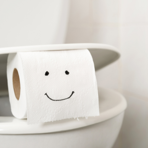 toilet roll on a toilet bowl with a smile drawn on it